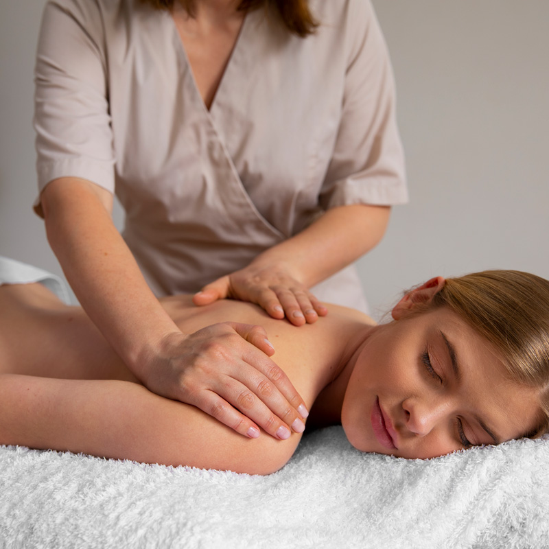 woman getting back massage from masseur